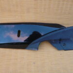 Petit flanc de carénage sous marche pied gauche de Honda 125 S-Wing